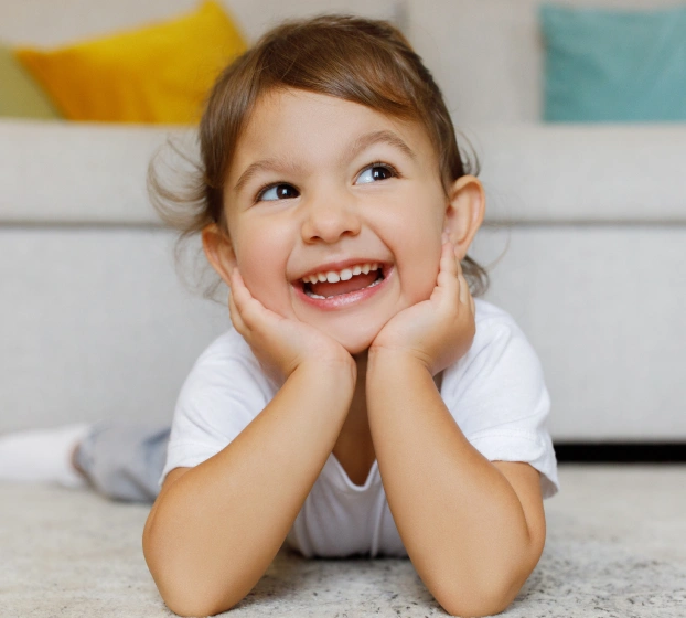 Happy child smiling after early intervention orthodontics at Aurora dental office.