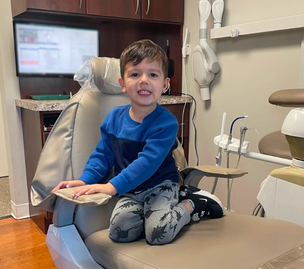 Young child in dental chair at first pediatric visit in Aurora, IL.