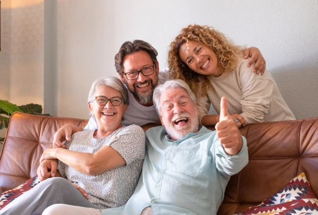 Happy multi-generational family smiling together at dental practice in Aurora, IL.