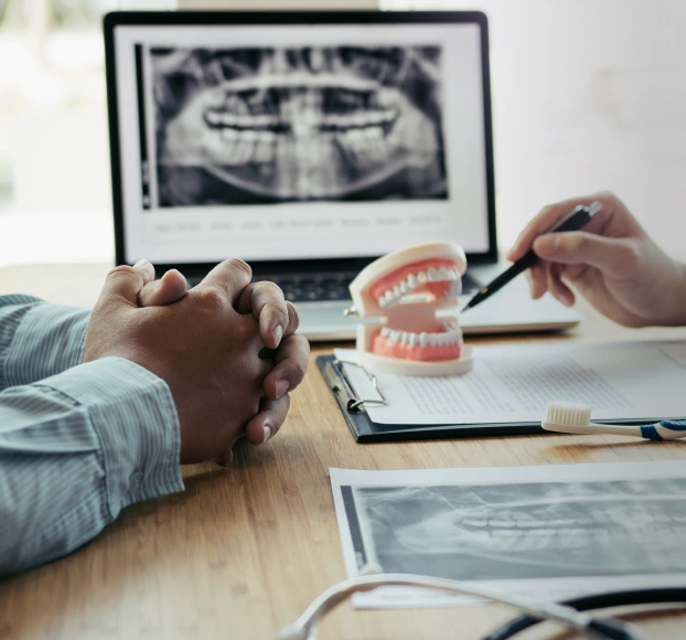 Dentist consulting with patient on insurance and payment options at Aurora, IL dental office.