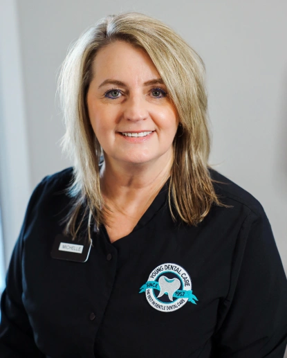 Michelle, dental hygienist at Aurora Dental in Aurora, IL, welcoming patients.