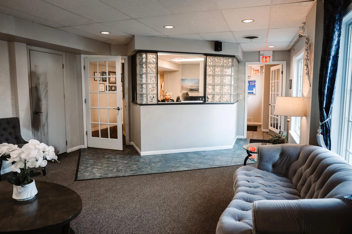 Modern reception and waiting area at dental practice in Aurora, IL with comfortable seating.
