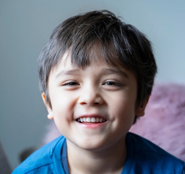 Happy young patient smiling after airway and growth treatment at Aurora dental practice in Illinois.