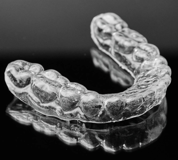 Clear night guard retainer for teeth grinding treatment in Aurora, IL.