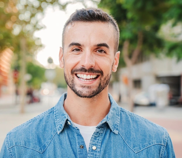 Smiling male patient after Opalescence Boost teeth whitening at dental office in Aurora, IL.
