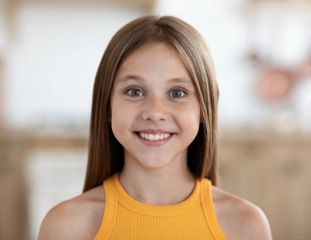 Happy young patient smiling at pediatric dentistry office in Aurora, IL.