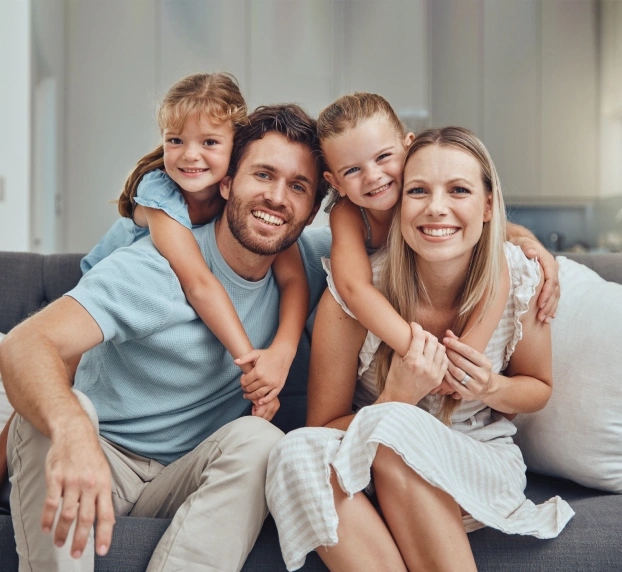 Happy family with two children smiling at preventive dental care appointment in Aurora, IL.