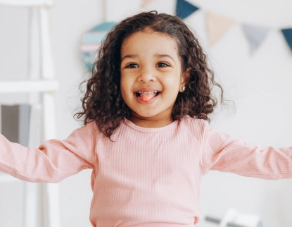 Happy child smiling after pediatric dental care at Aurora, IL practice.