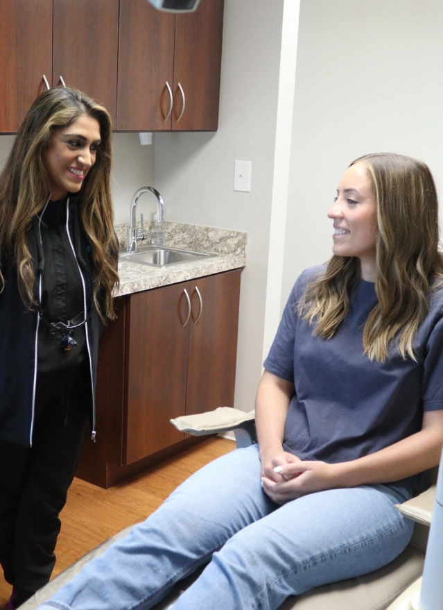 Dental hygienist consulting with patient at Aurora, IL dental office.