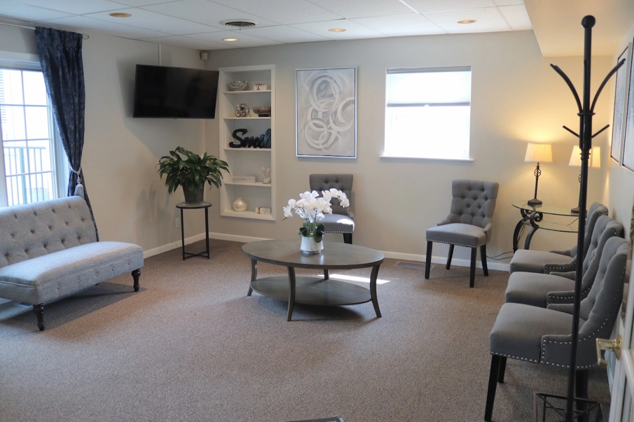 Welcoming waiting area at dental practice in Aurora, IL with comfortable seating and modern décor.