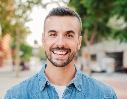 Smiling patient after cosmetic dentistry treatment at Aurora, IL dental office.