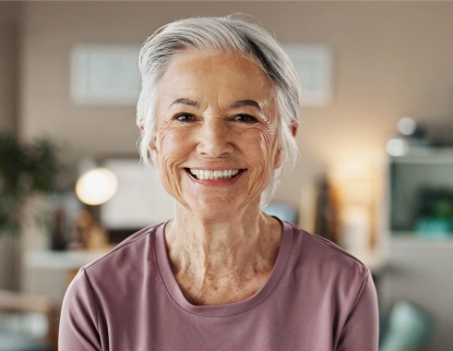 Smiling woman patient after dental implants at Aurora, IL dental office.