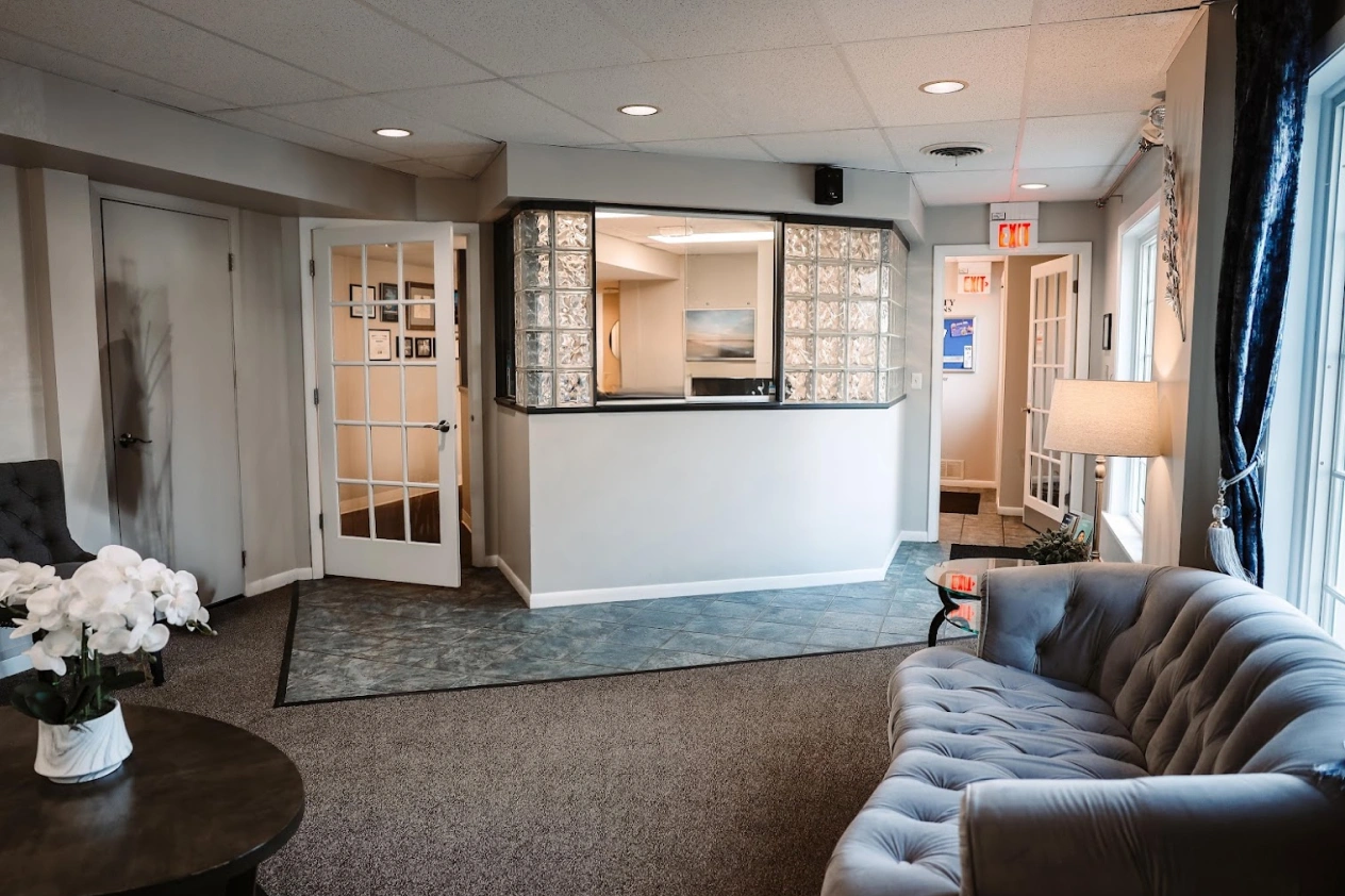 Modern dental reception area and waiting room at Aurora dental office with comfortable seating.