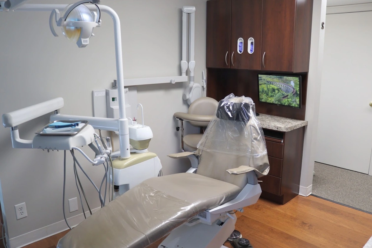 Modern dental operatory with treatment chair, overhead light, and equipment at Aurora dental office in Illinois.
