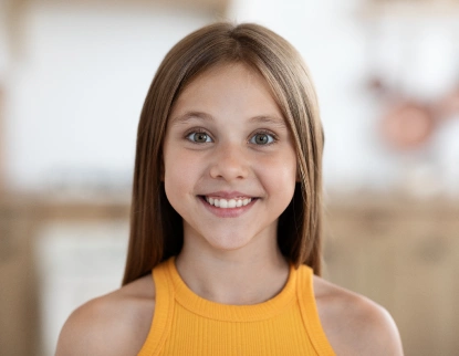 Happy young patient smiling at pediatric dentistry appointment in Aurora, IL.